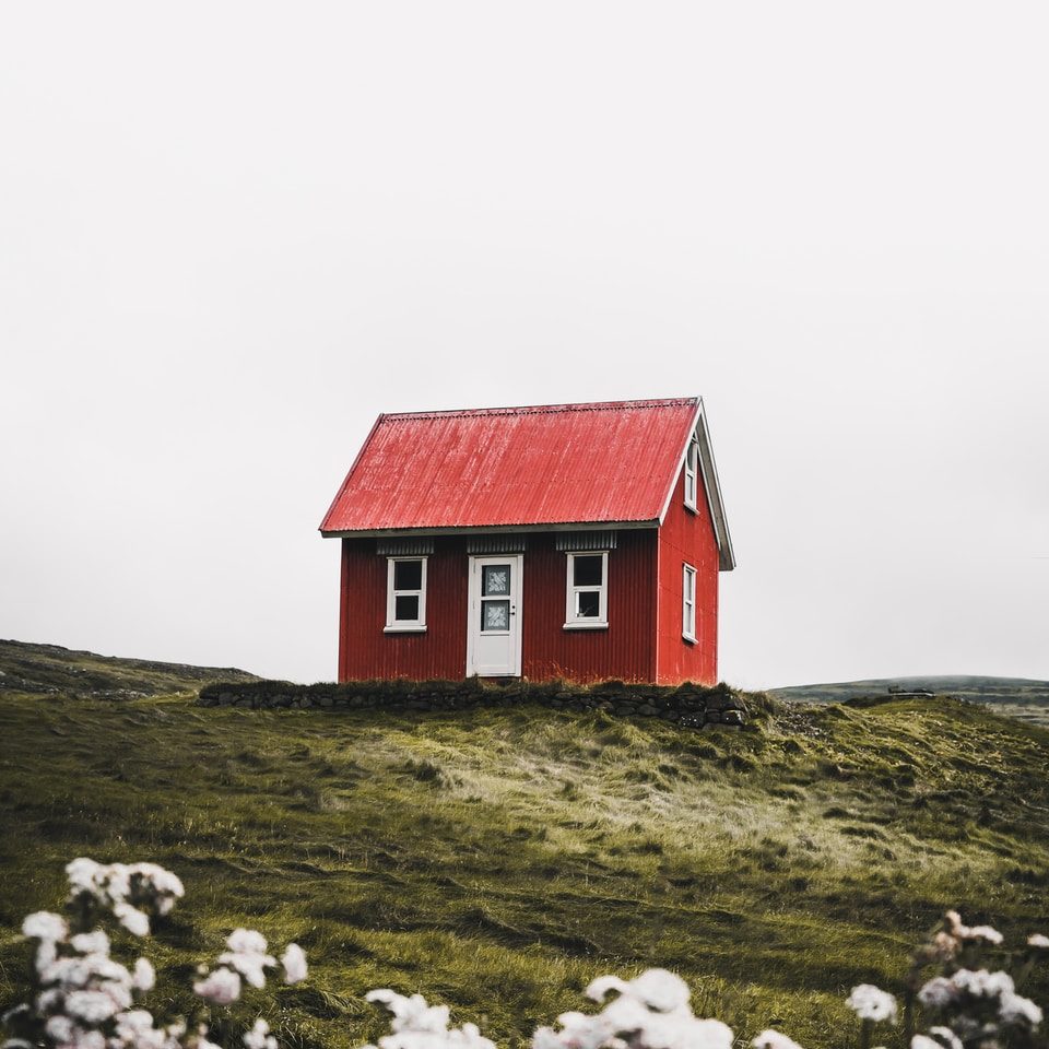 red and white house surround green grass field
