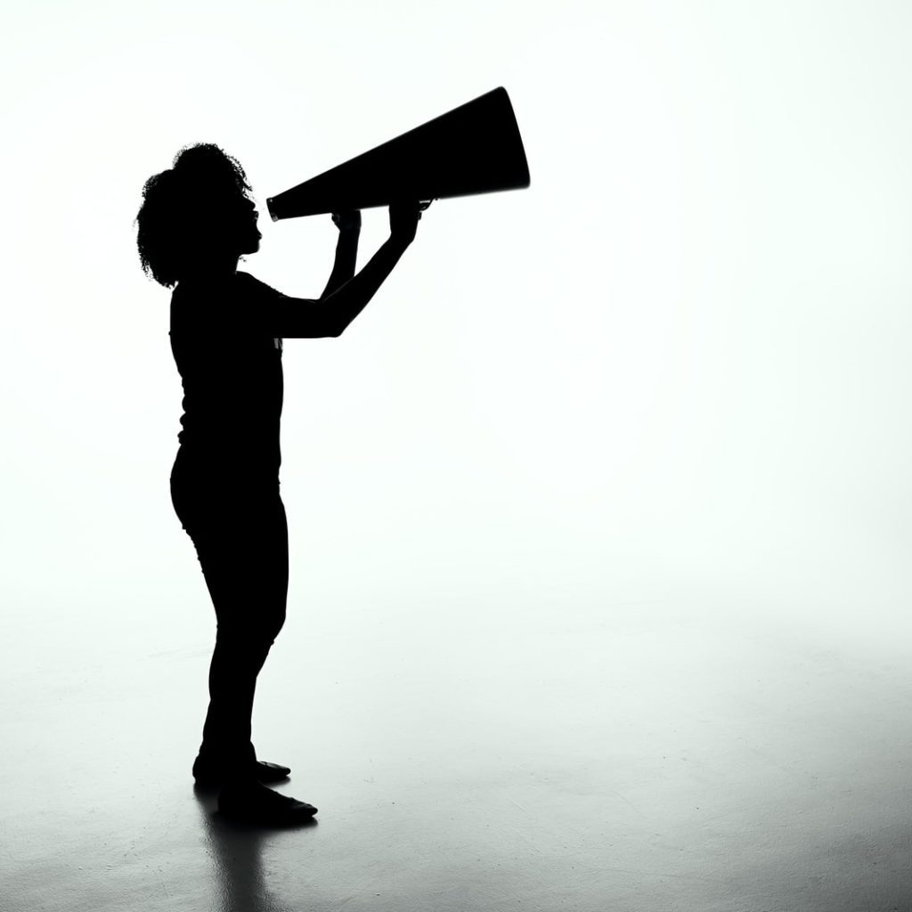 silhouette of woman holding rectangular board